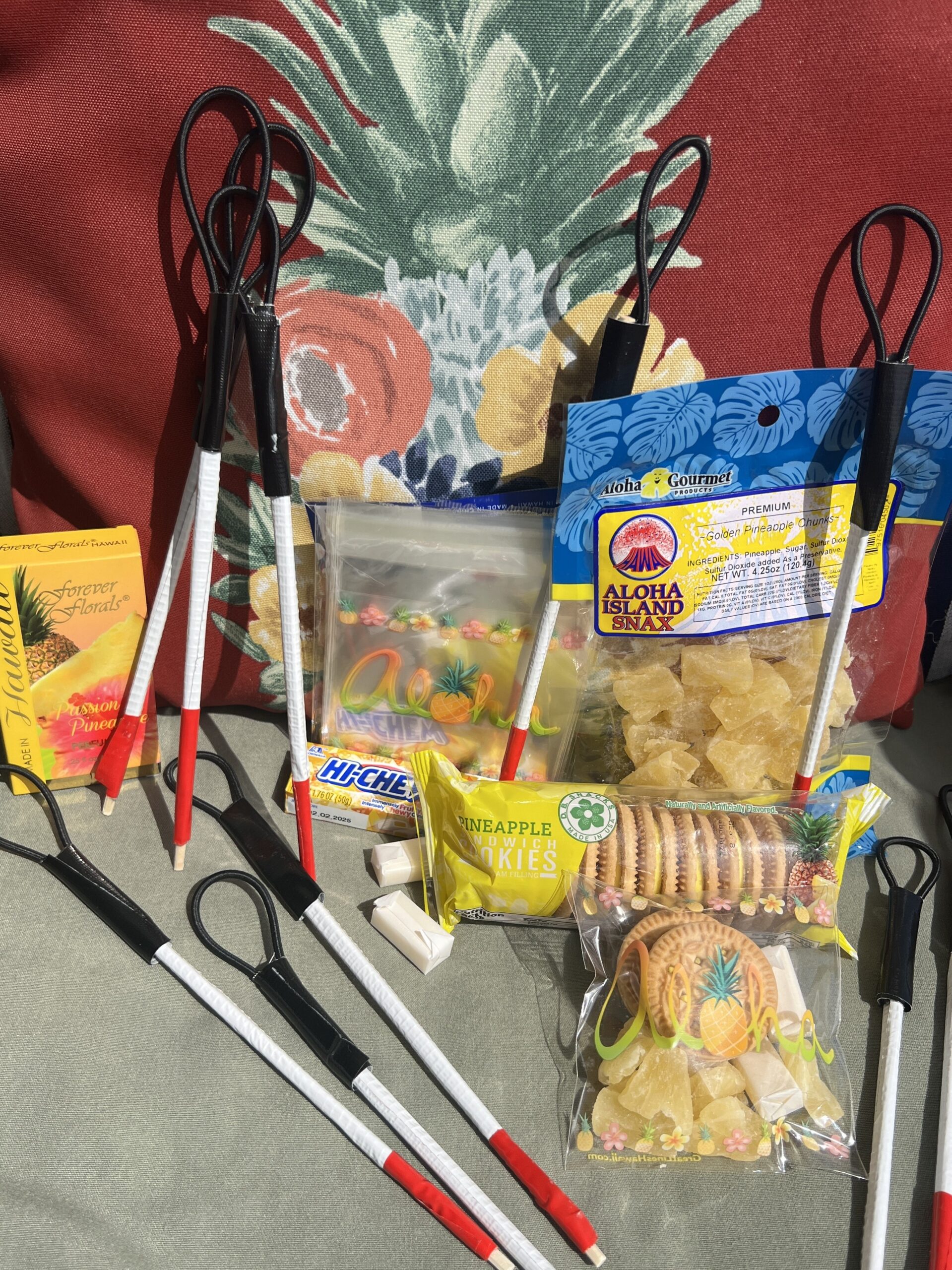 Image Description of Picture Below: Tiny white canes with pineapple treat bags given to workshop participants of “Pineapples and White Canes”